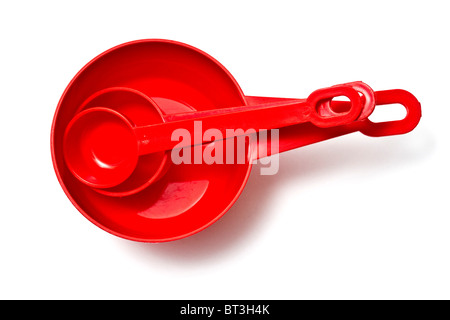 Set of red plastic measuring cups isolated on white background Stock Photo