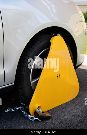 A clamped car parked in a residential area UK Stock Photo