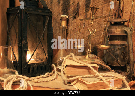 Still life - old lamps, books and balance on wooden background Stock Photo