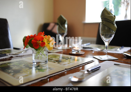 Table laid out in dining room ready for Sunday lunch Stock Photo