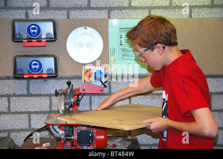 schoolboy in woodworking class Stock Photo