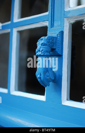 Blue hand door knocker in Treguier, in the Brittany region of France Stock Photo