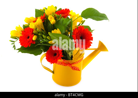 Flower bouquet with orange Gerber and yellow Freesia in watering can Stock Photo