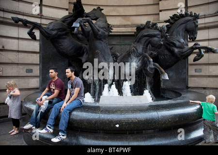 The Horses of Helios statue and fountain in Piccadilly in central London. Tourists gather and have photographs taken. Stock Photo