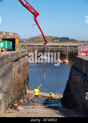 Workmen at work on the harbour, Padstow, Cornwall, UK Stock Photo