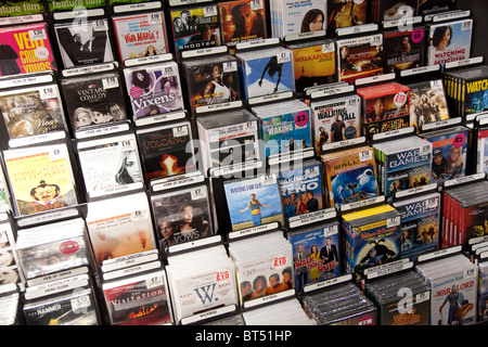 DVDs for sale in a home entertainment store in London. Racks of DVD movies at HMV. Stock Photo