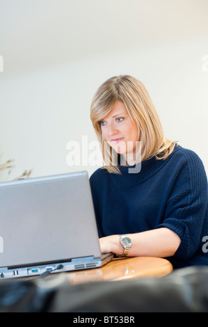Pretty, young woman with her laptop studying for an exam/working Stock ...