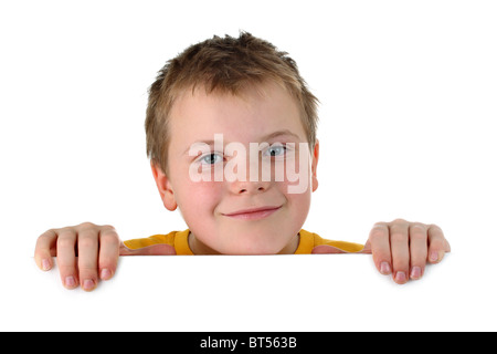 Small boy looking out of a blank whiteboard smiling isolated on white Stock Photo
