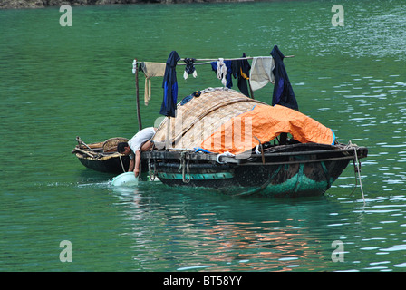 Fisherman on houseboat in Halong Bay, Vietnam Stock Photo