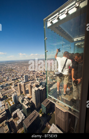 Tourists in the all glass balcony Skydeck observation deck view the Chicago skyline103rd floor of the Willis Sears Tower Stock Photo