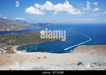 The view on top of volcanic crater in Vulcano Island with volcanic smoke by the feet. Stock Photo