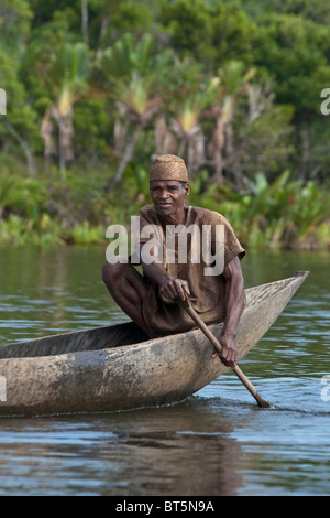 Man in pirogue, Canal des Pangalanes, Madagascar. Stock Photo