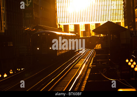 Sunrise illuminates the elevated tracks of the Chicago rapid transit system known as the'L' in Chicago, IL, USA. Stock Photo