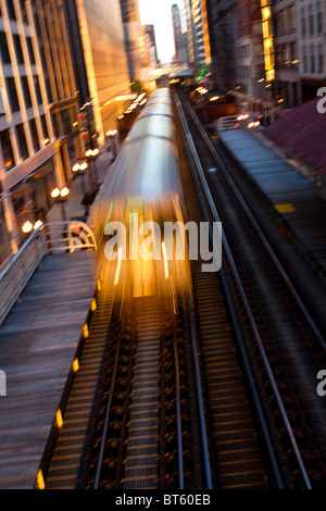 Sunrise illuminates a train in the Chicago rapid transit system known as the'L' in Chicago, IL, USA. Stock Photo