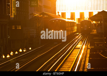 Sunrise illuminates the elevated tracks of the Chicago rapid transit system known as the'L' in Chicago, IL, USA. Stock Photo