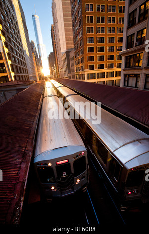 Sunrise illuminates a train in the Chicago rapid transit system known as the'L' in Chicago, IL, USA. Stock Photo
