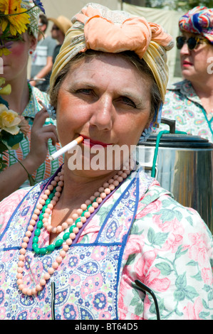 2010 Glastonbury Festival of Contemporary Performing Arts festival Tea lady fag cigarette bead beads scarf head woman female red Stock Photo