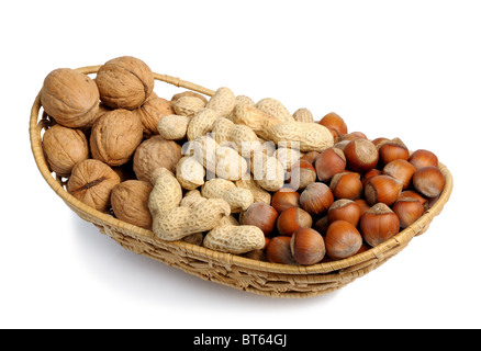 Set of nuts in a wicker basket, isolation Stock Photo