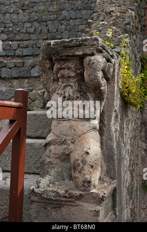 The small Atlantes which adorn the lower part of the end walls of the cavae in the  Odeon small theatre, Pompeii, Italy Stock Photo