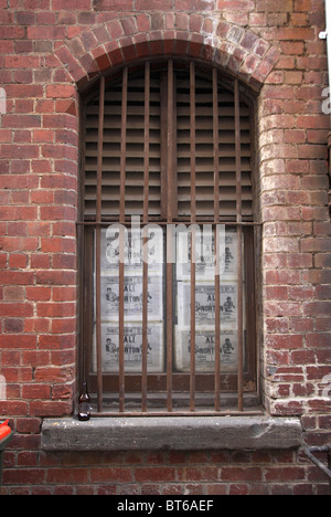 Window with bars on brick building in Melbourne, Australia Stock Photo