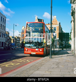 Front view of 243 double-decker red bus waiting stopped at a bus stop destination Wood Green via Dalston at Hoxton in East London England UK Stock Photo