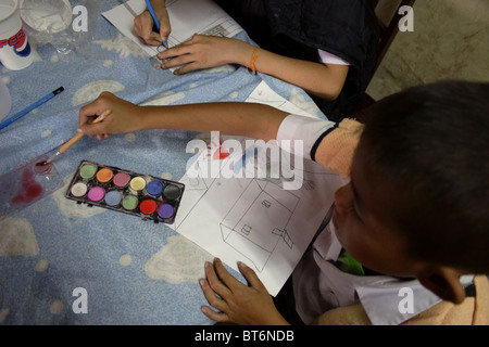 Deaf students are painting with watercolors during classes at the National Rehabilitation Center in Vientiane, Laos. Stock Photo