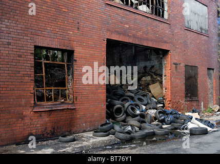 Old buildings adjacent to Liverpool Docks abandoned and falling into disrepair alongside the Dock Road in Liverpool Stock Photo