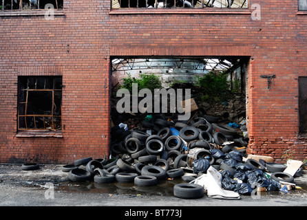 Old buildings adjacent to Liverpool Docks abandoned and falling into disrepair alongside the Dock Road in Liverpool Stock Photo