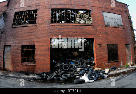 Old buildings adjacent to Liverpool Docks abandoned and falling into disrepair alongside the Dock Road in Liverpool Stock Photo