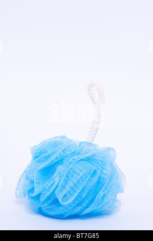 A close up photo of a blue bath scrunchie for washing against a white background Stock Photo