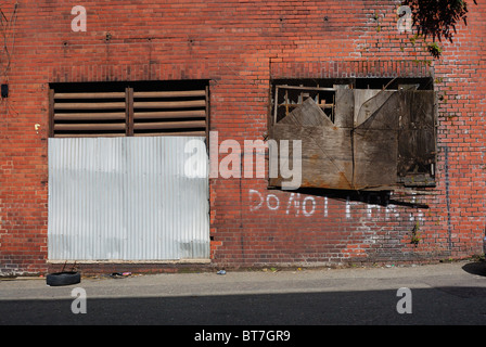 Old buildings adjacent to Liverpool Docks abandoned and falling into disrepair alongside the Dock Road in Liverpool Stock Photo