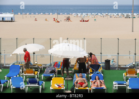 People sunbathing in front of the Figueira da Foz beach, Portugal Stock Photo