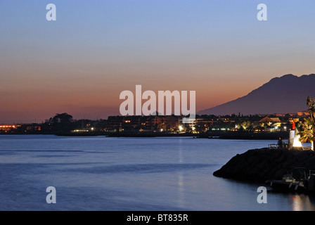 Harbour mouth and coastline at sunset, Puerto Banus, Marbella, Costa del Sol, Malaga Province, Andalucia, Spain, Western Europe. Stock Photo