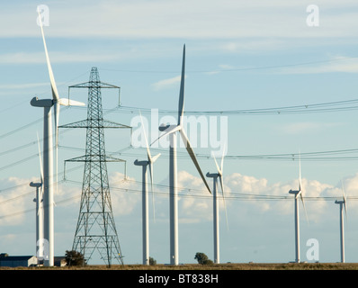 National Grid electricity transmission lines and pylons next to Nordex wind turbines at Little Cheyne Court wind farm Rye Sussex Stock Photo