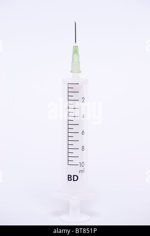 A close up photo of a syringe and needle against a white background Stock Photo