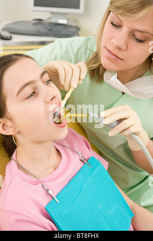 Dental nurse checking a girl's teeth Stock Photo