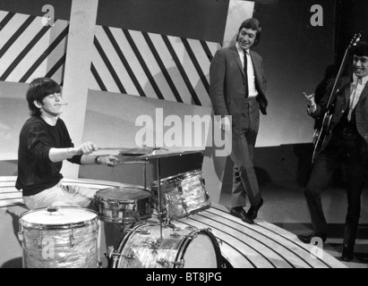 ROLLING STONES  Drummer Charlie Watts and Bill Wyman (right) are amused as Keith Richards tries the drums in 1964 Stock Photo