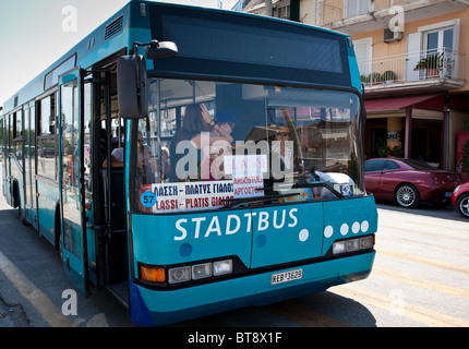 passengers boarding local bus at Sami .Island of Cephalonia.Greece.Lady bus driver. Stock Photo