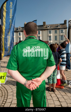 Rear back view of A St John Ambulance male man paramedic UK Stock Photo