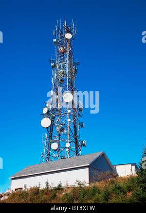 A communication tower against a clear blue sky. Stock Photo