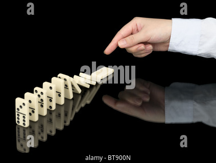 Domino effect in operation on a black background Stock Photo