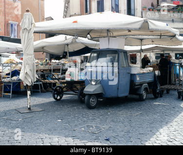 Market stand with umbrellas and a blue Piaggio transporter on Campo dei Fiori in Rome, Italy Stock Photo