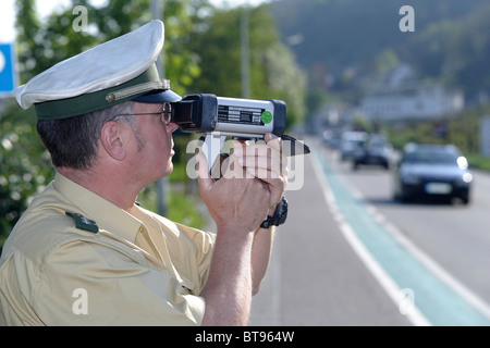 A police officer doing speed monitoring with a laser gun, Koblenz, Rhineland-Palatinate, Germany, Europe Stock Photo