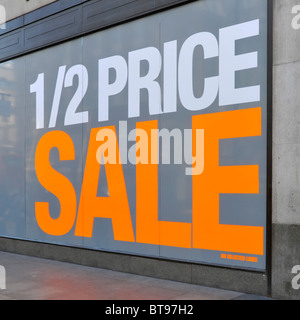 Large shop window poster promoting half price sale (store name digitally removed) Stock Photo