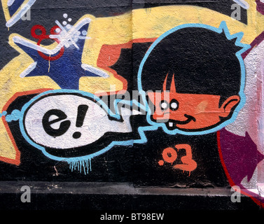 Graffito showing a children's head (youngster] and a speech bubble with the characters "e!" on a wall in Munich, Germany Stock Photo