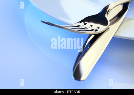 Dinner plate, knife and fork place setting Stock Photo