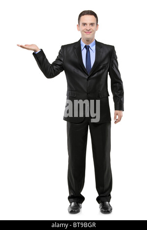 Full length portrait of a man in a suit with right hand lifted Stock Photo