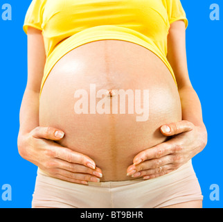pregnant mother holding her stomach Stock Photo - Alamy