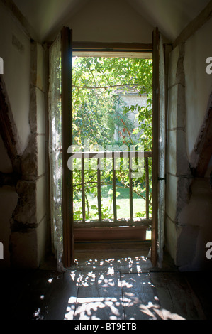 An open door looking out over a garden Stock Photo