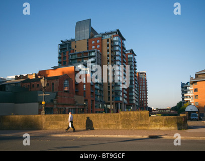 Early morning  office worker  crossing the Albert Bridge over the river Irwell Left Bank manchester Stock Photo